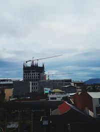 Crane against sky in city