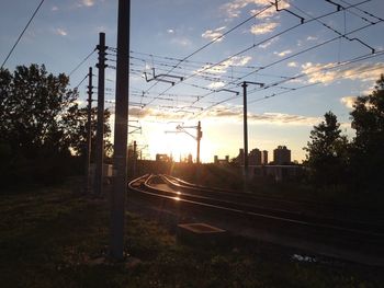 Railroad tracks against cloudy sky