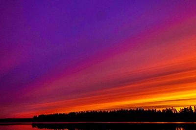 Scenic view of silhouette trees against sky at night