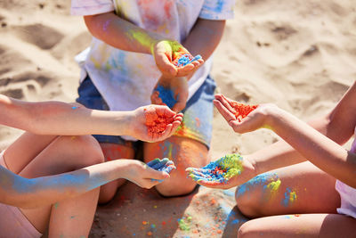 Low section of friends playing at beach