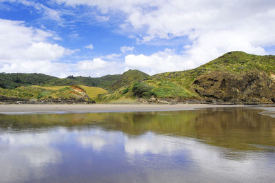 Scenic view of lake and mountains against sky