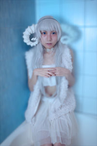 Portrait of a girl standing against wall