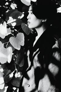 Close-up of woman with flowers on tree