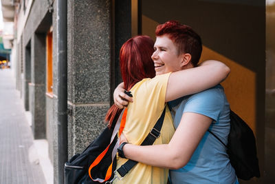 Friends embracing each other in campus