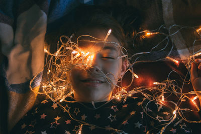 Close-up of girl with illuminated lights