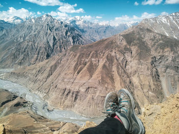 Low section of person on snowcapped mountain