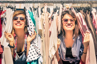 Cheerful friends amidst clothing