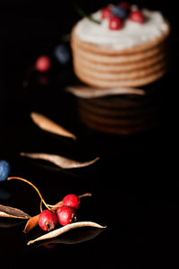 Close-up of strawberry on table against black background