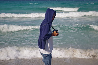 Full length of man standing on beach