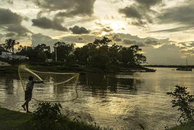 Scenic view of lake against sky at sunset