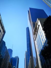 Low angle view of modern buildings against clear blue sky