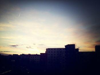 Buildings in city at sunset