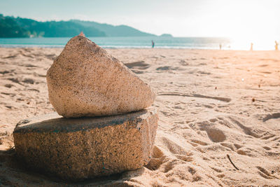 Close-up of sand on beach against sky
