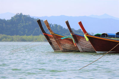 Fishing boat in sea against sky