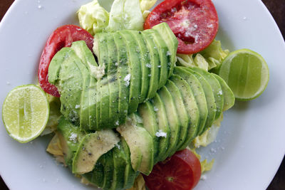 Avocado salada with ripe tomatoes and lime juice