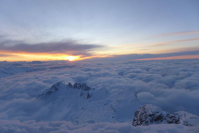 Scenic view of snow against sky during sunset