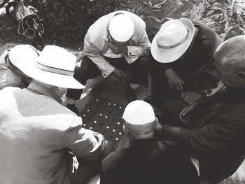 High angle view of people holding hat