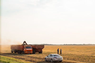 Tractor on field against sky