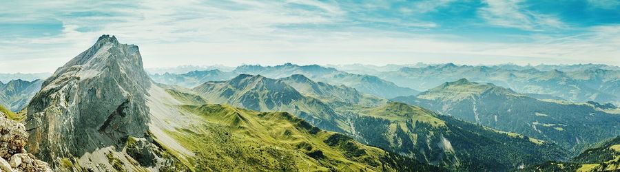Scenic view of mountains against cloudy sky