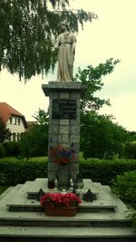 Low angle view of statue against trees in park