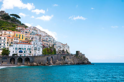 Scenic view of village on hill at mediterranean coastline