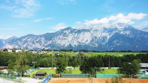 Scenic view of trees and mountains against sky