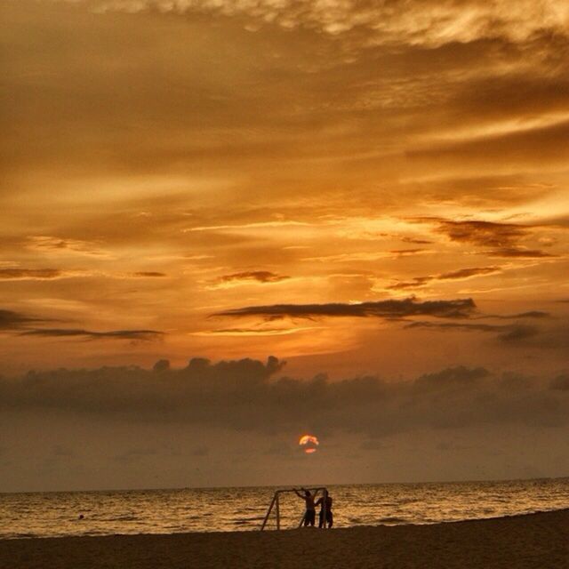 sea, sunset, horizon over water, beach, silhouette, water, sky, scenics, beauty in nature, tranquil scene, tranquility, shore, cloud - sky, leisure activity, orange color, nature, idyllic, lifestyles