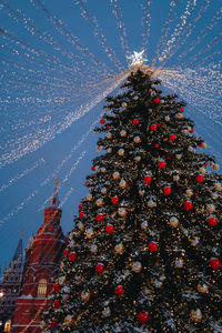 Festive sparkling garlands and shiny decorations with christmas tree as symbol of happy new year