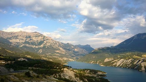 Scenic view of mountains against cloudy sky