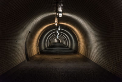 Silhouette of single pedestrian on the end of tunnel in prague