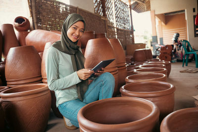 Portrait of woman using digital tablet in workshop