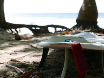 Chairs on beach against sky