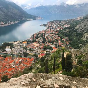 High angle view of townscape by mountain against sky