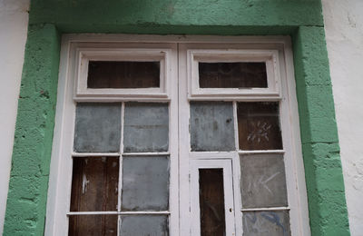 Low angle view of closed window of old building