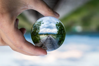 Close-up of hand holding crystal ball