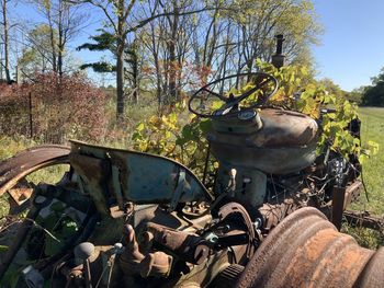 Old abandoned vintage car on field