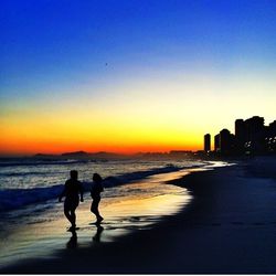 Silhouette of people on beach