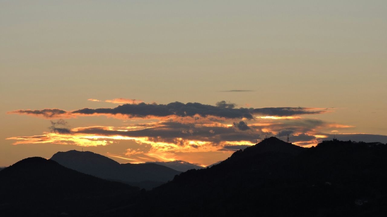 sunset, silhouette, mountain, scenics, tranquil scene, beauty in nature, tranquility, sky, mountain range, orange color, nature, idyllic, landscape, majestic, cloud - sky, cloud, outdoors, non-urban scene, dramatic sky, no people