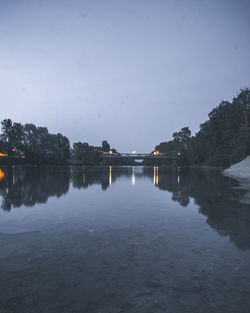 Scenic view of lake against clear sky at night