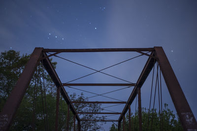 Low angle view of bridge against sky at night