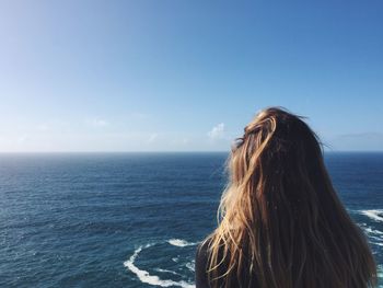 Rear view of woman against sea