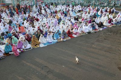 High angle view of woman praying on street during eid-ul-fitr