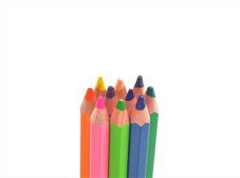 Close-up of multi colored pencils against white background