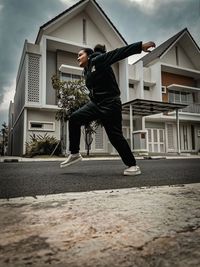 Man jumping outside house