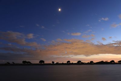 Scenic view of lake against sky at sunset