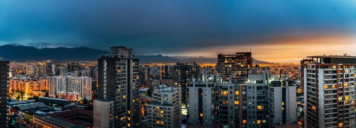 High angle view of illuminated cityscape against sky during sunset