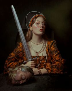 Portrait of medieval woman holding a sword 