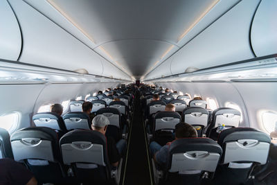 Rear view of people sitting in airplane