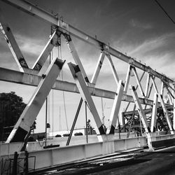 Cranes at harbor against sky