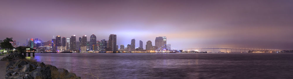 Illuminated city at waterfront